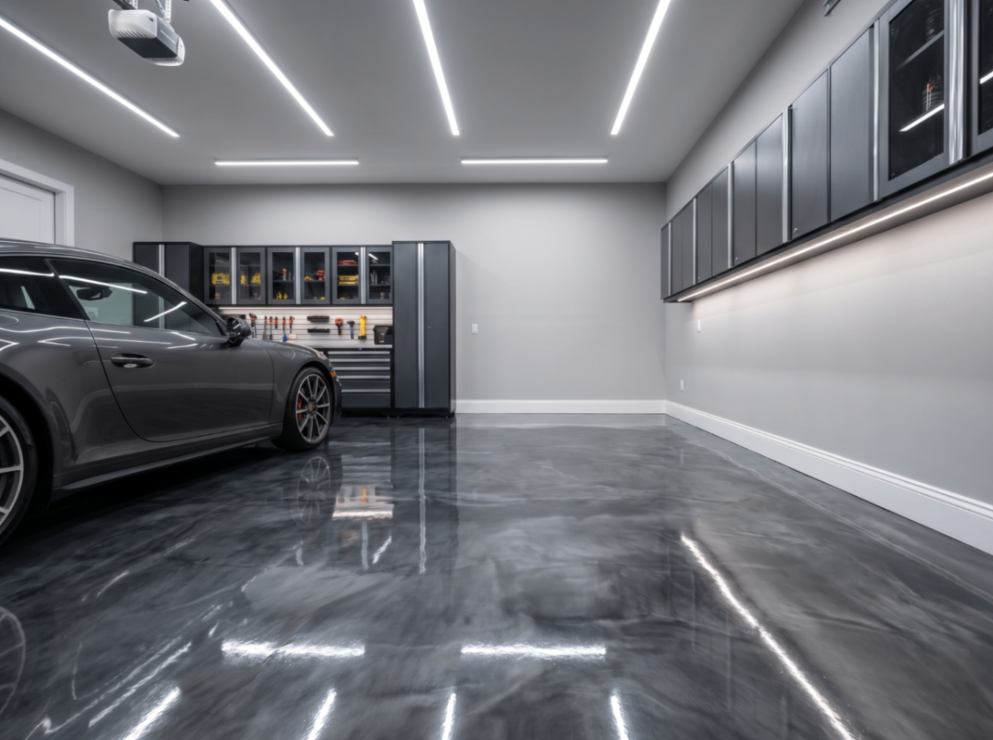 High-gloss epoxy garage floor with luxury car and cabinetry.